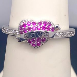Pink and clear crystal stones set in a silver tone with love in the center heart